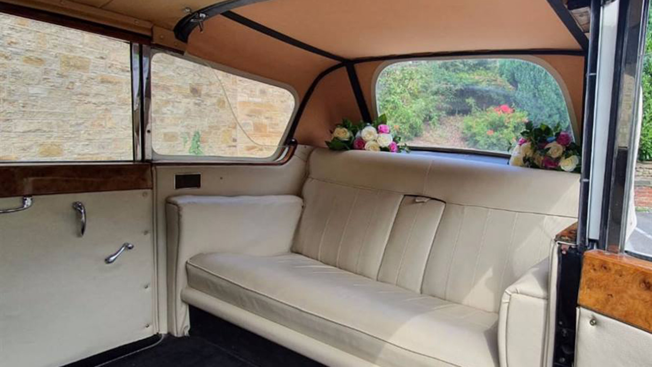 Cream leather rear bench seat inside the classic austin princess