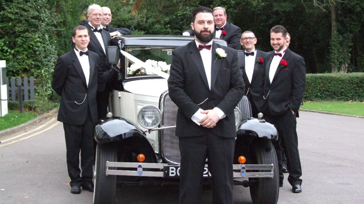 Groomsmen standing all around the Bramwith Wedding Car