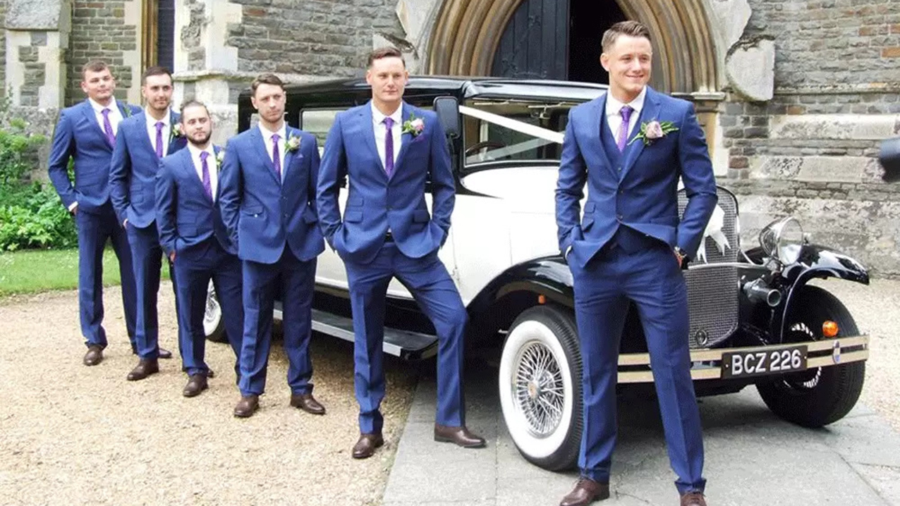 Groomsmen standing in front of the Bramwith with their matching navy blue suit