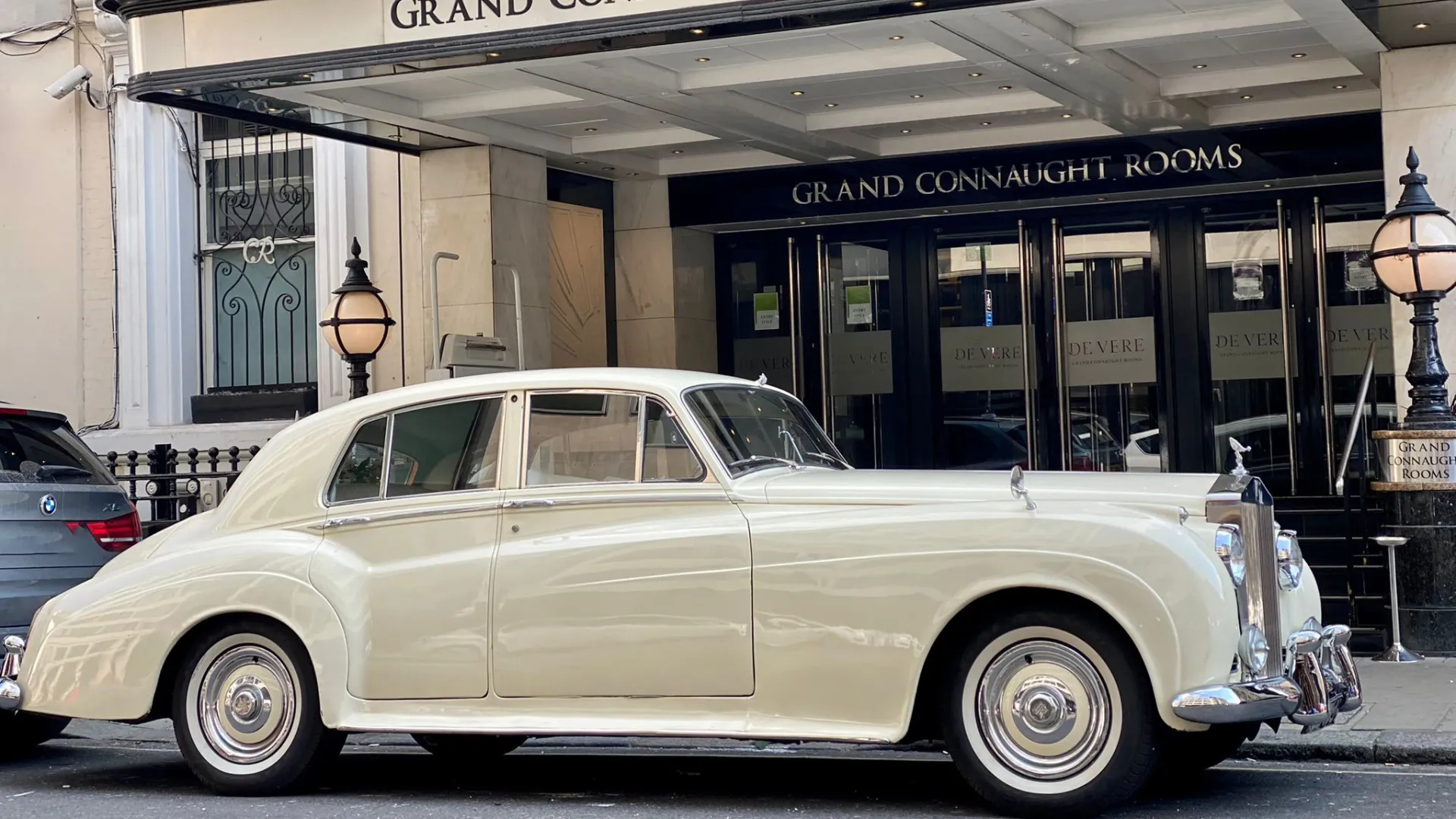 Classic rolls-Royce Silver Cloud decorated with Wedding Ribbons in front of Connaught Hotel in London