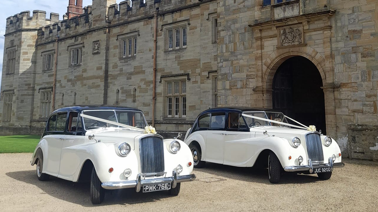 Two Matching Ausint Princess wedding cars decorated with ribbons