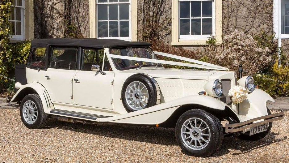 Side view of Convertible Beauford with White Ribbons accross bonnet and closed up  Black Soft-Top Roof