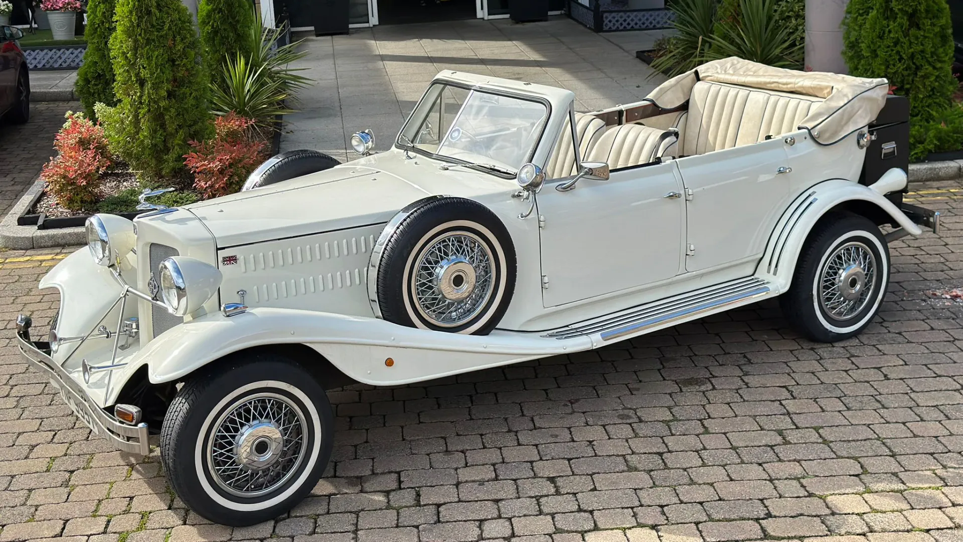 Front Side View of Convertible Beauford with roof down and tucked away in ivory Cover