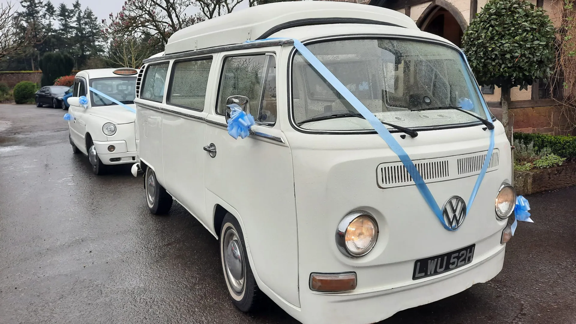 Classic Volkswagen Baywindow Campervan decorated with Blue Ribbons folowed by a Taxi Cab with Matching Blue Ribbons