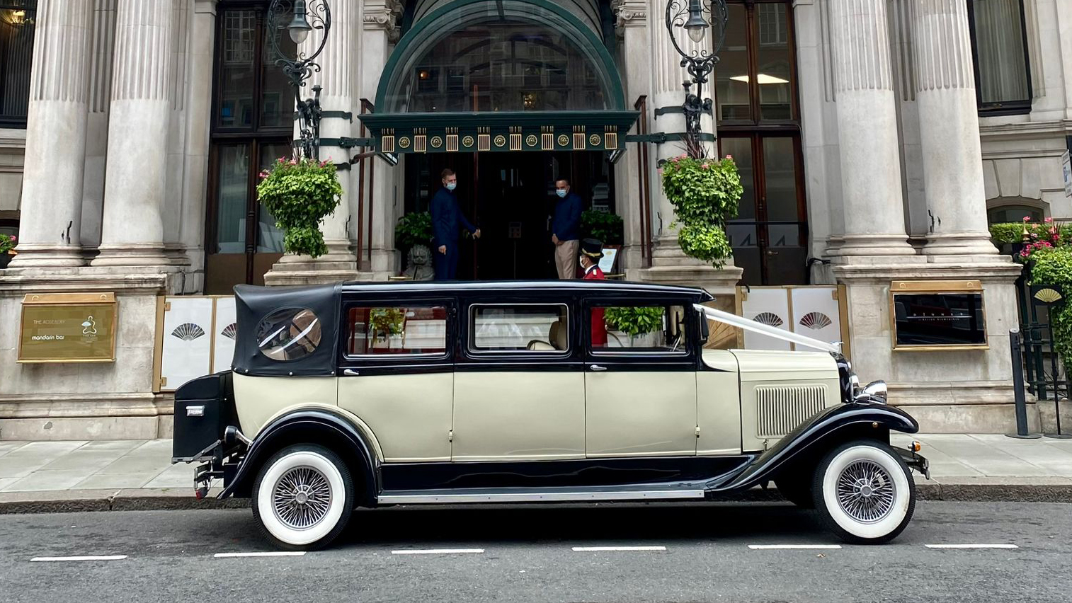 Vintage style Ivory Bramwith in front of wedding venue in London