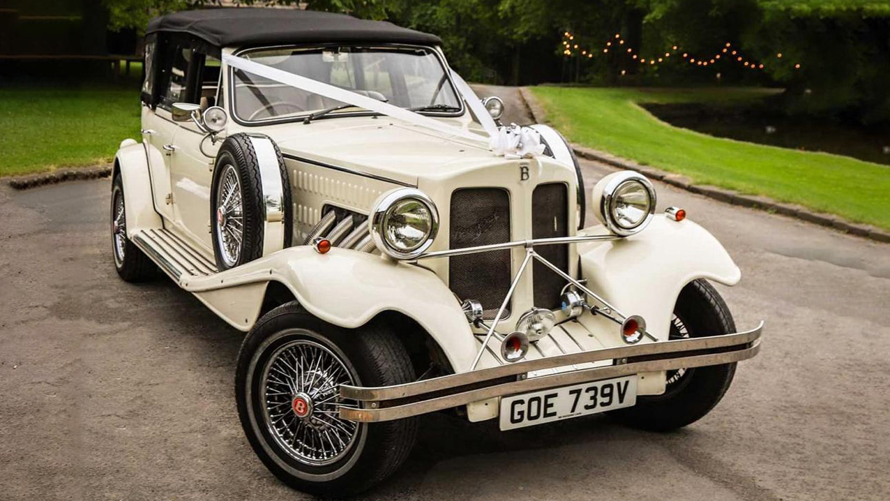 Fron view of BEauford Convertible with Black Soft Roof Up, White V-Shape Ribbons accross its bonnet