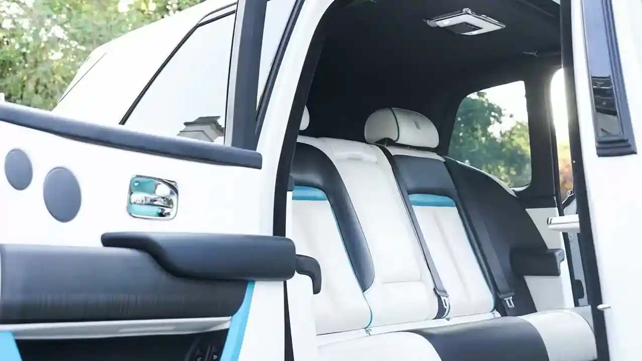 rear interior view of White Leather seats with Turquoise Blue Pipping