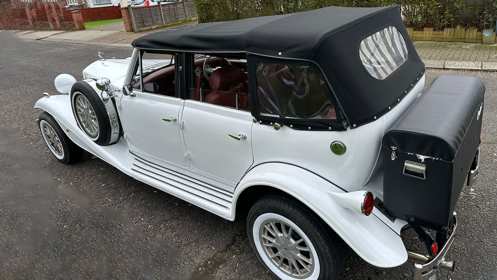 White Beauford 4-Door Convertible with soft top black roof up