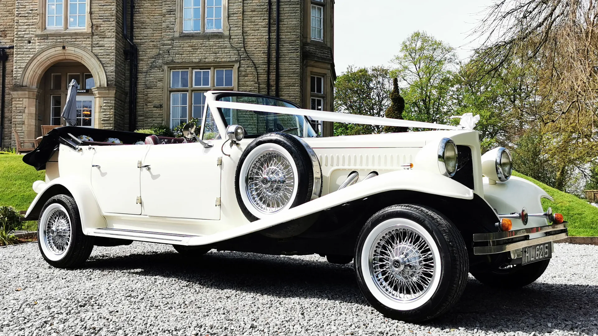 Side View of Beauford Convertible decorated with White ribbons with convertible Black soft top Roof is down