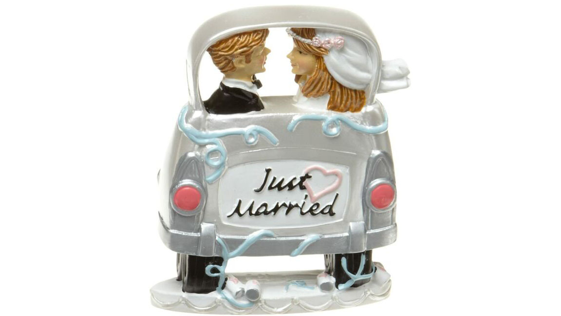 Wedding Cake Topper feature a Bride and Groom in a Car with a "Just Married" sign