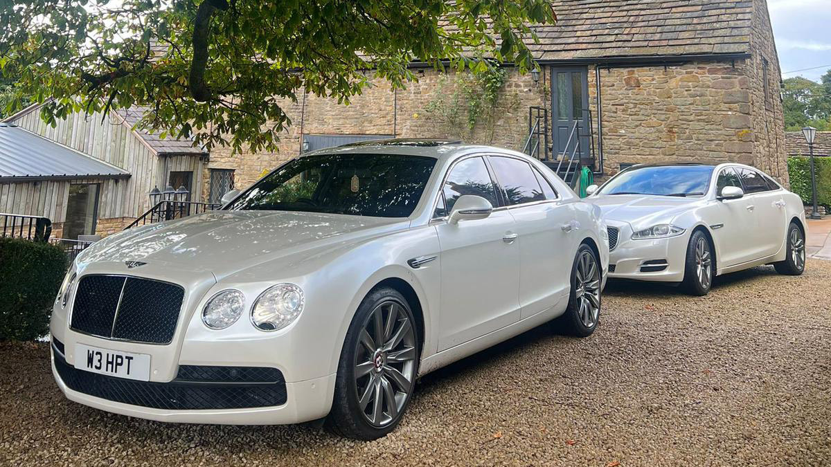 Bentley Flying Spur in White followed by a White Jaguar in attendance at a wedding