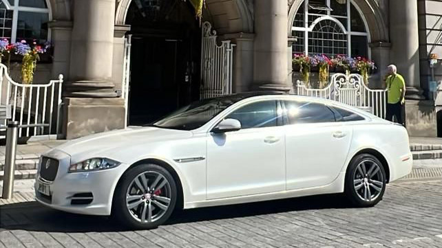 Left Side View of White Jaguar in front of wedding venue in Manchester