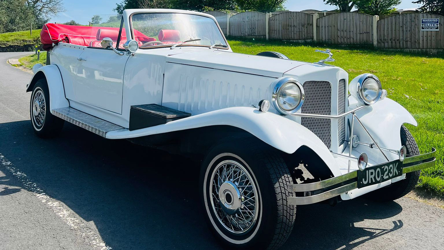 Right side view of White BEauford Convertible with roof down
