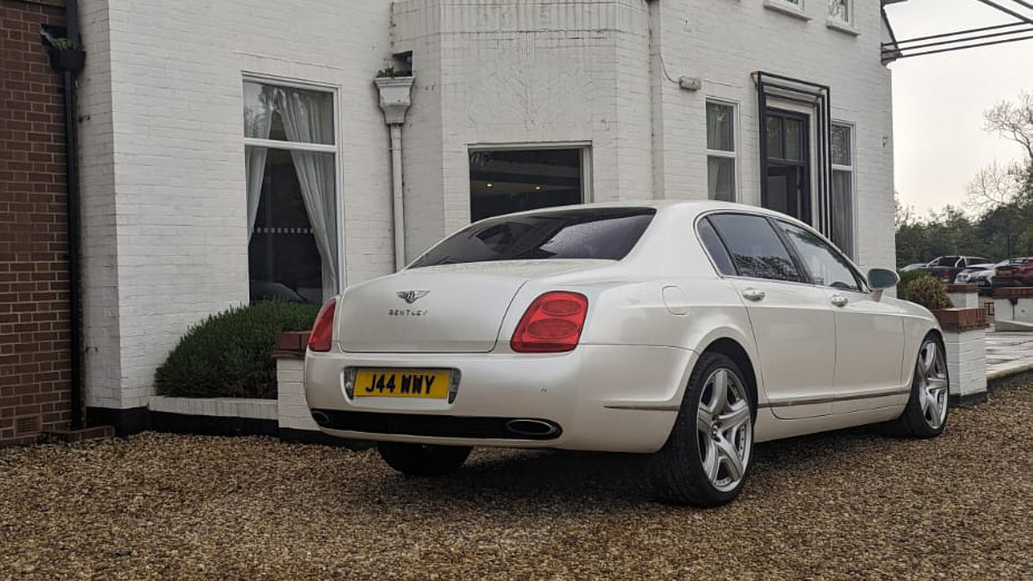 Side Rear view of White Bentley