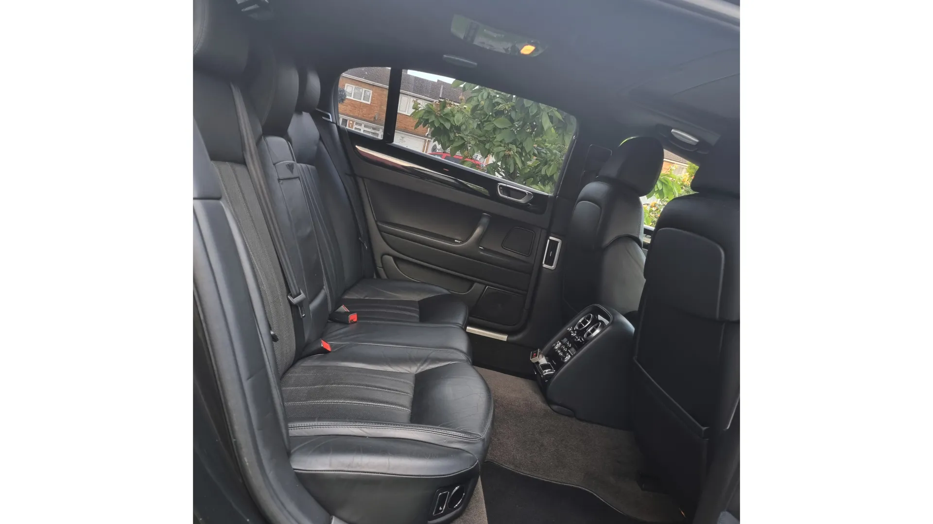 Balck Leqather rear interior with seating for 3 passengers showing a very large legroom