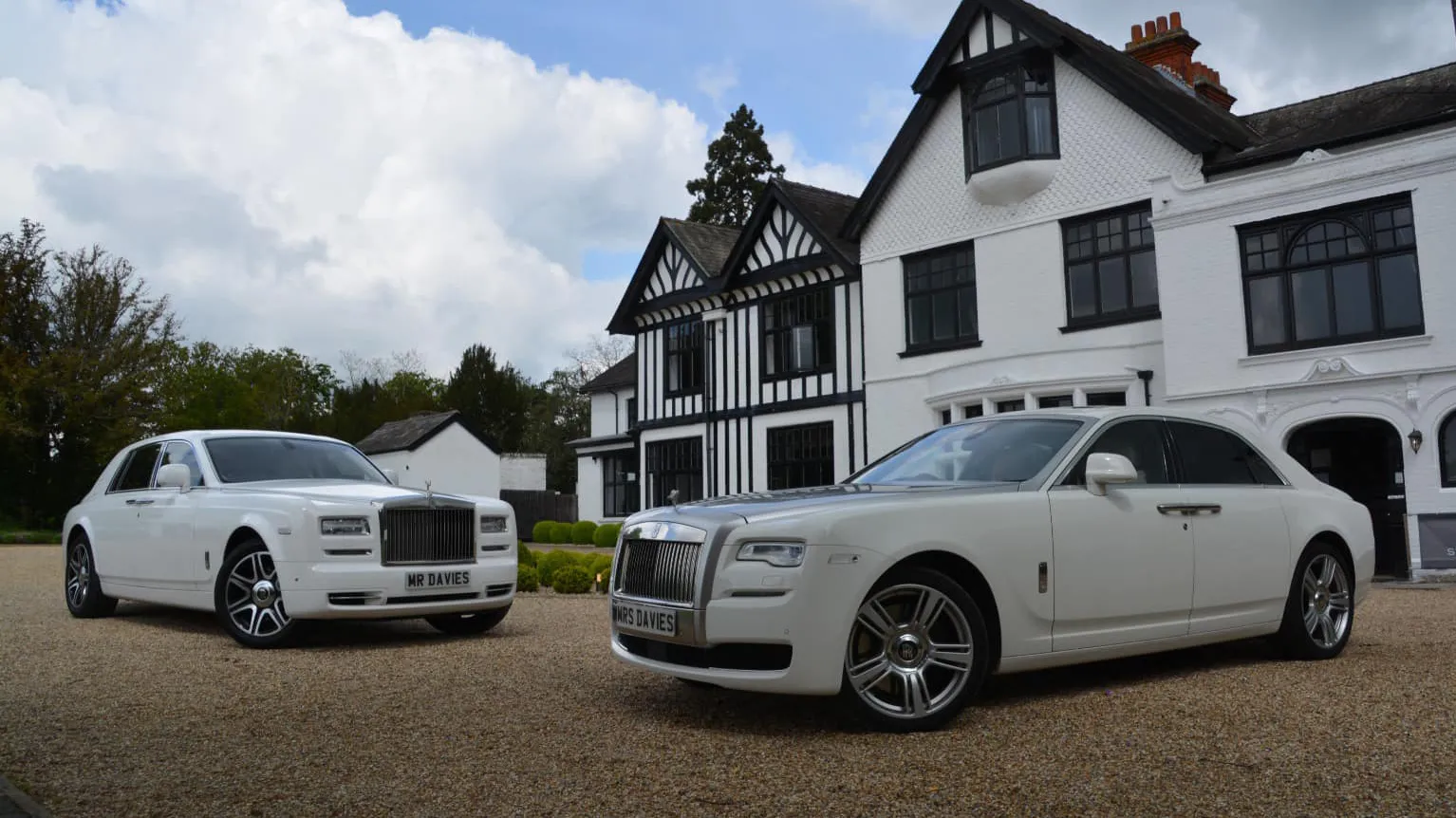 Two Modern Rolls-Royce Phantom and Ghost in White in front of a wedding venue in Maidstone