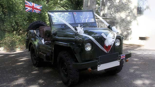 A Unique Military Wedding Car for hire in Army Green decorated with ribbons