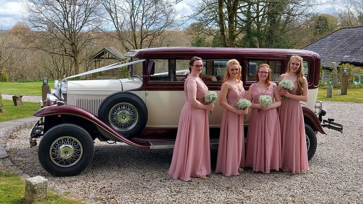 Bramwith Limousine with four bridesmaids holding wedding flowers in their hands