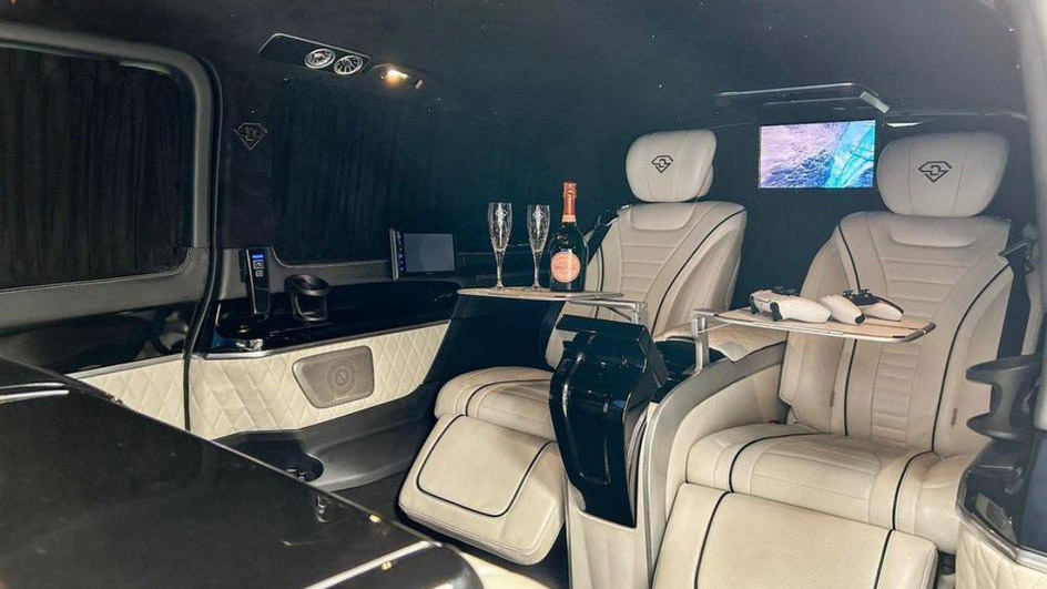 interior of Mercedes customized by Driven showing cream leather interior and large TV