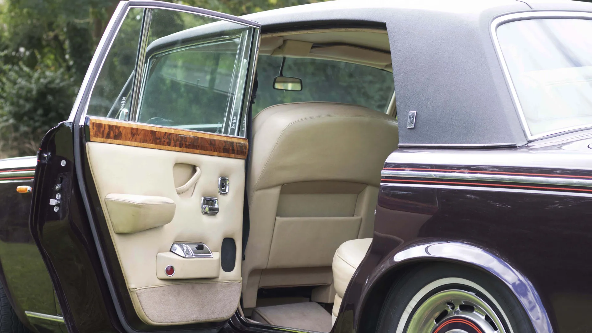 Rear left door open showing large amount of space in the rear. Cream door cards and seats