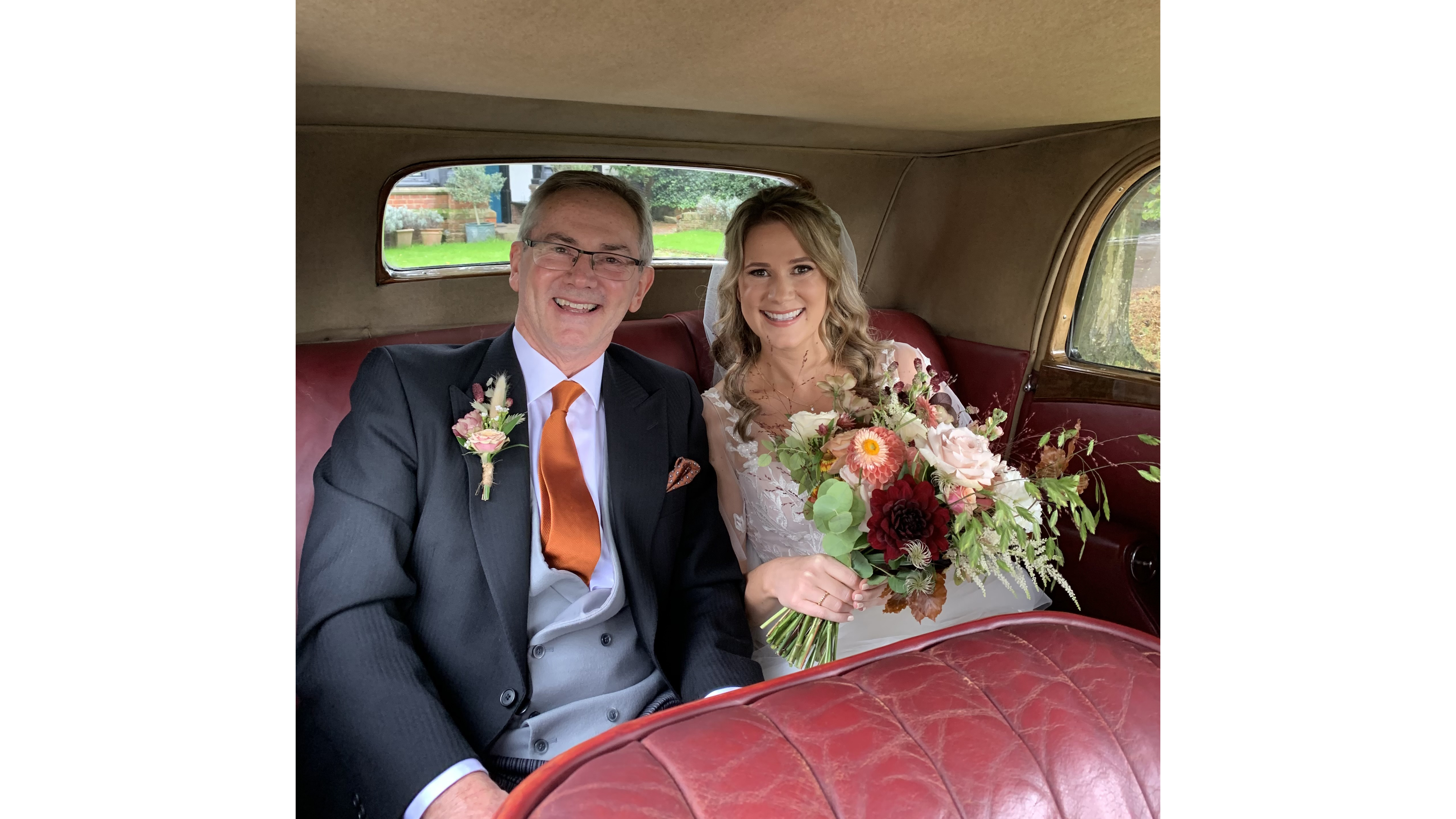 Bride and Father seated in the back of the vintage Rolls-Royce Phantom