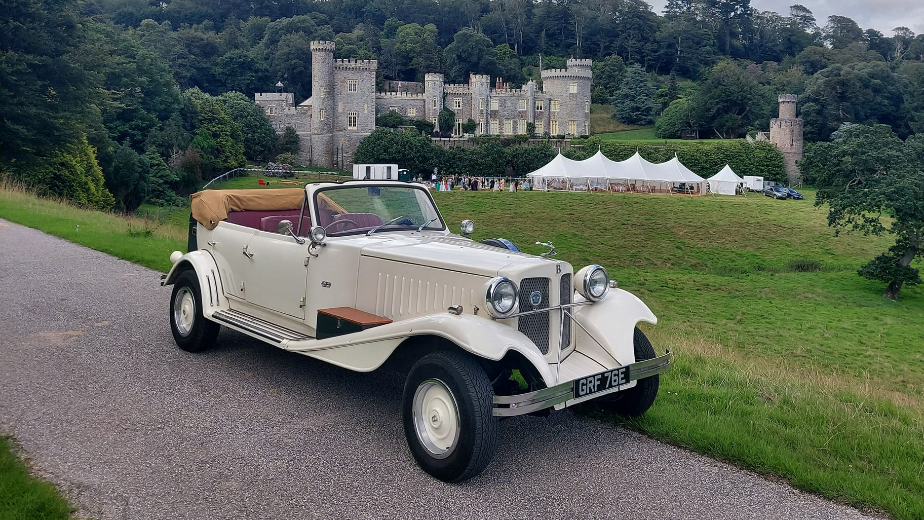 Beauford 4 Door Convertible with roof down and wedding castle in the background