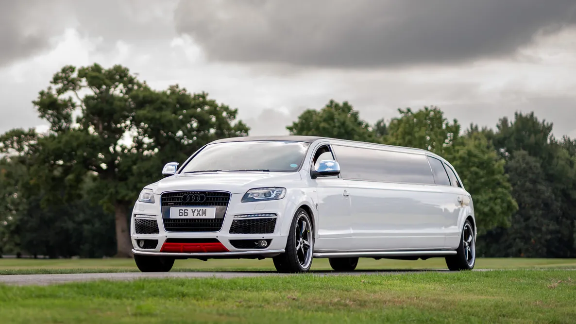 Modern white Audi Q7 stretched limousine entering a local wedding venue in Chester.