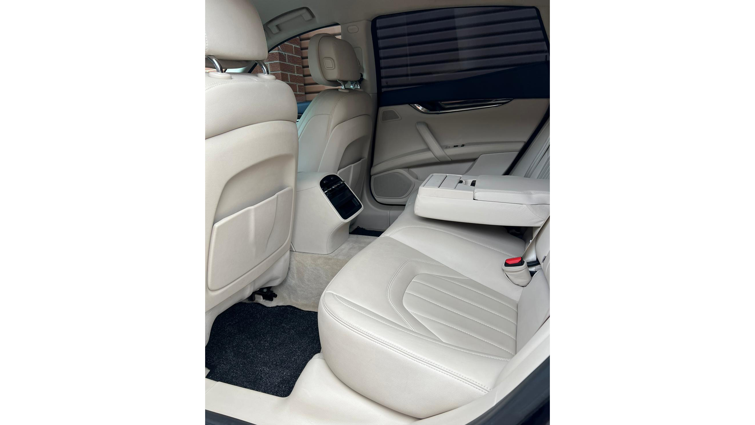 cream leather interior rear seating area in white maserati