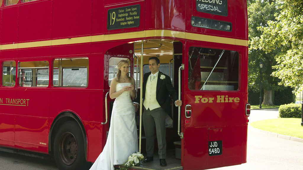 Bride and Groom on rear open platform of Routemaster Bus