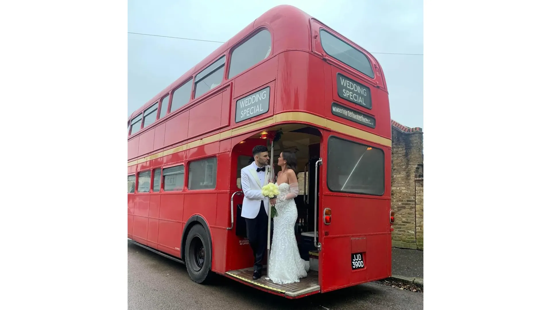 Bride and Groom standing on the rear open platform of Red Routemaster Bus