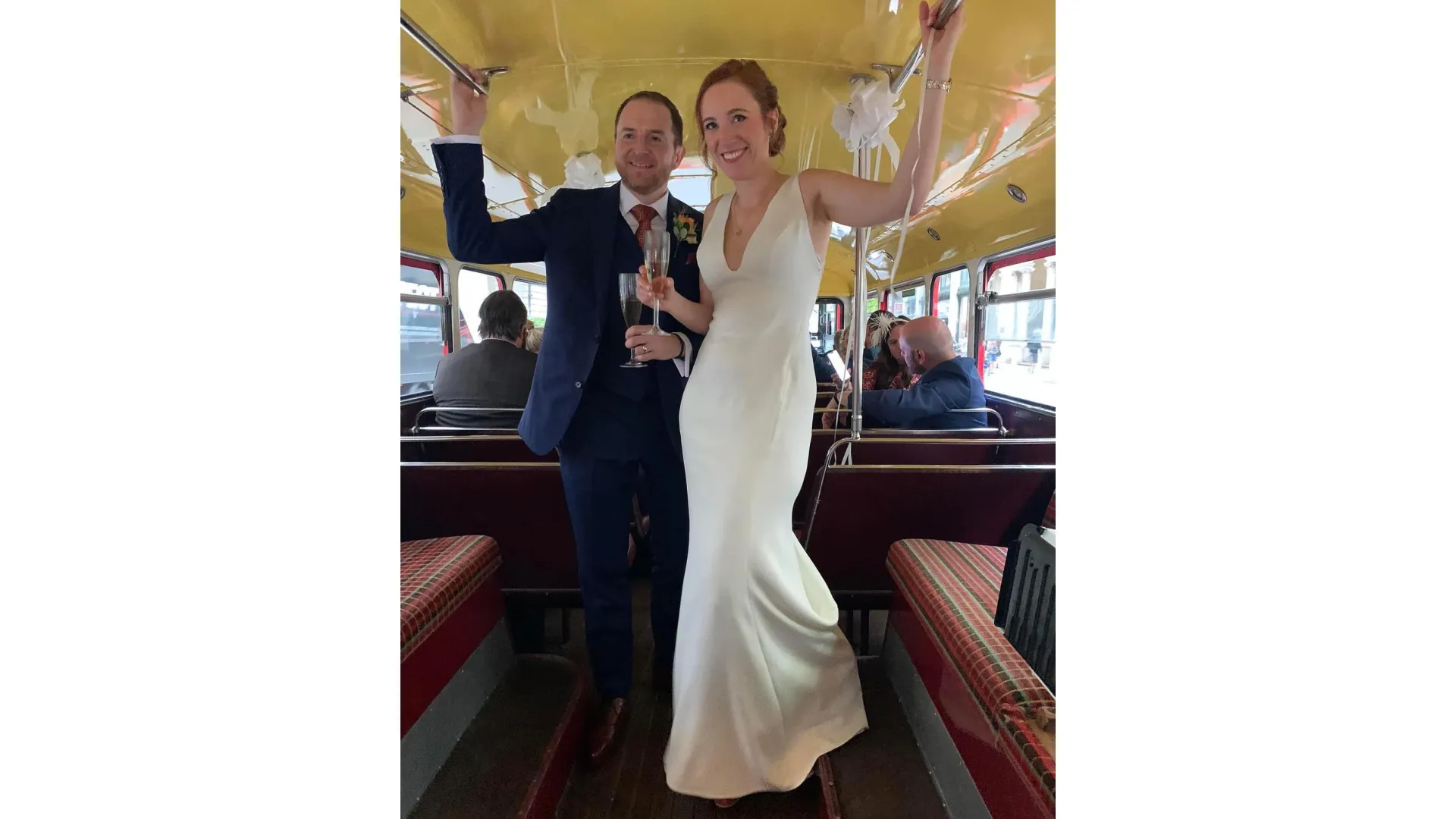 Bride and Groom smiling inside a Routemaster Bus