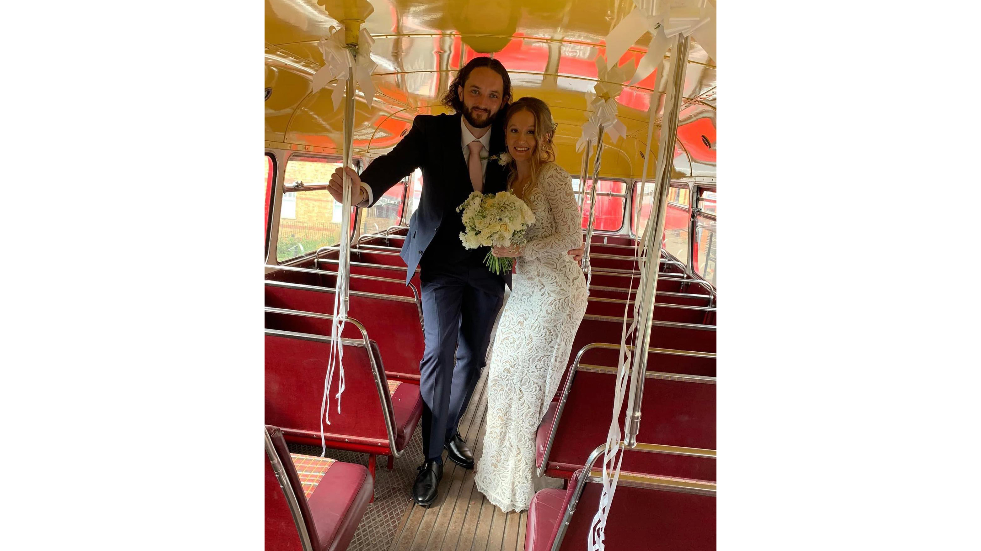 Bride and Groom holding each other inside a Routemaster Bus