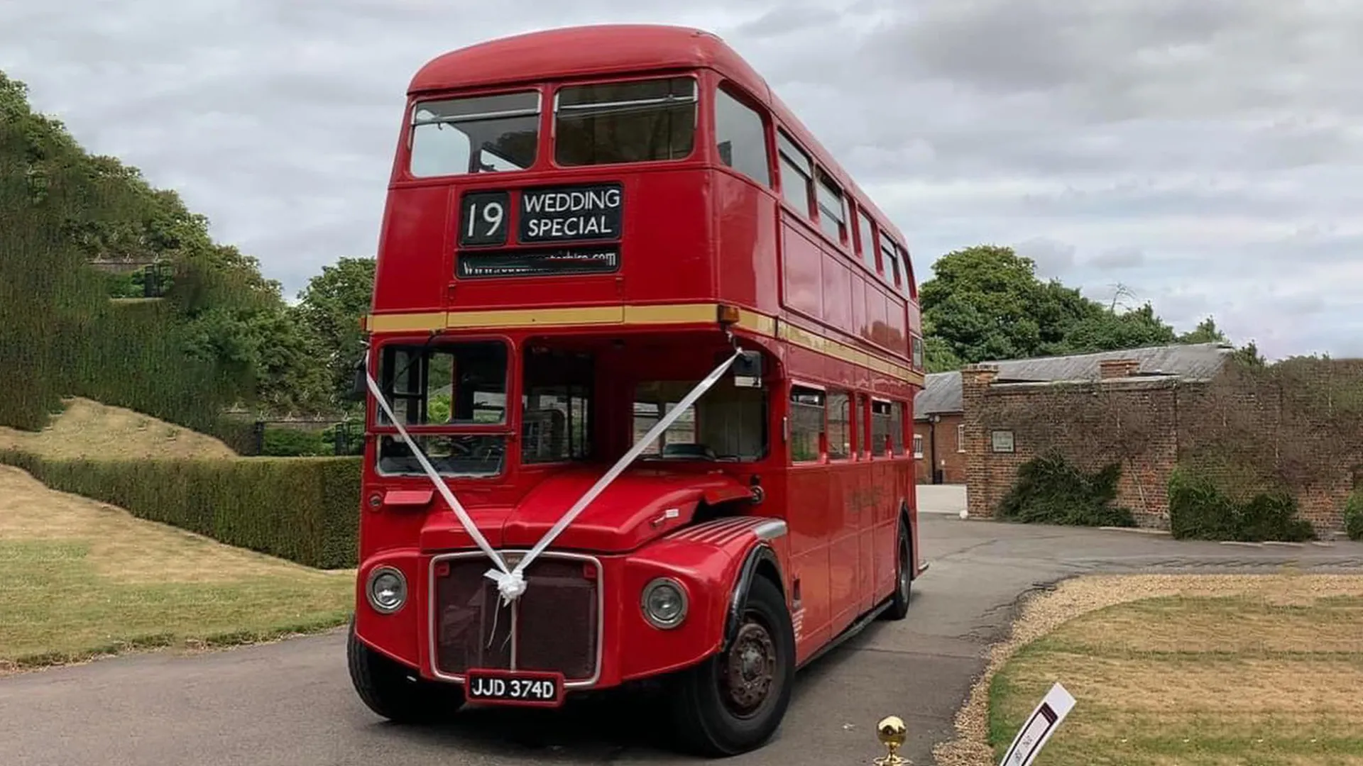 Red Double Decker Routemaster Bus with White Ribbons