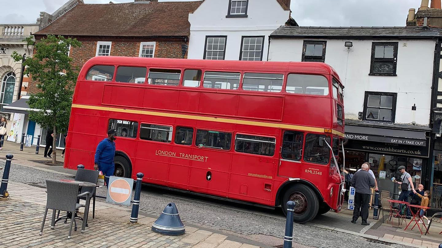 Red Routemaster Bus with guests around it