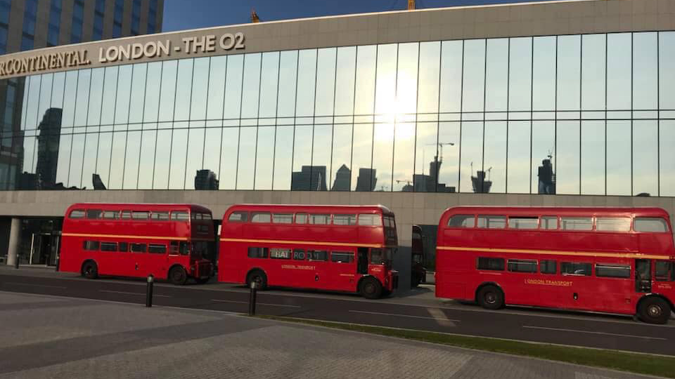 Three identical Routemaster Buses parked in front of the O2 Arena in London