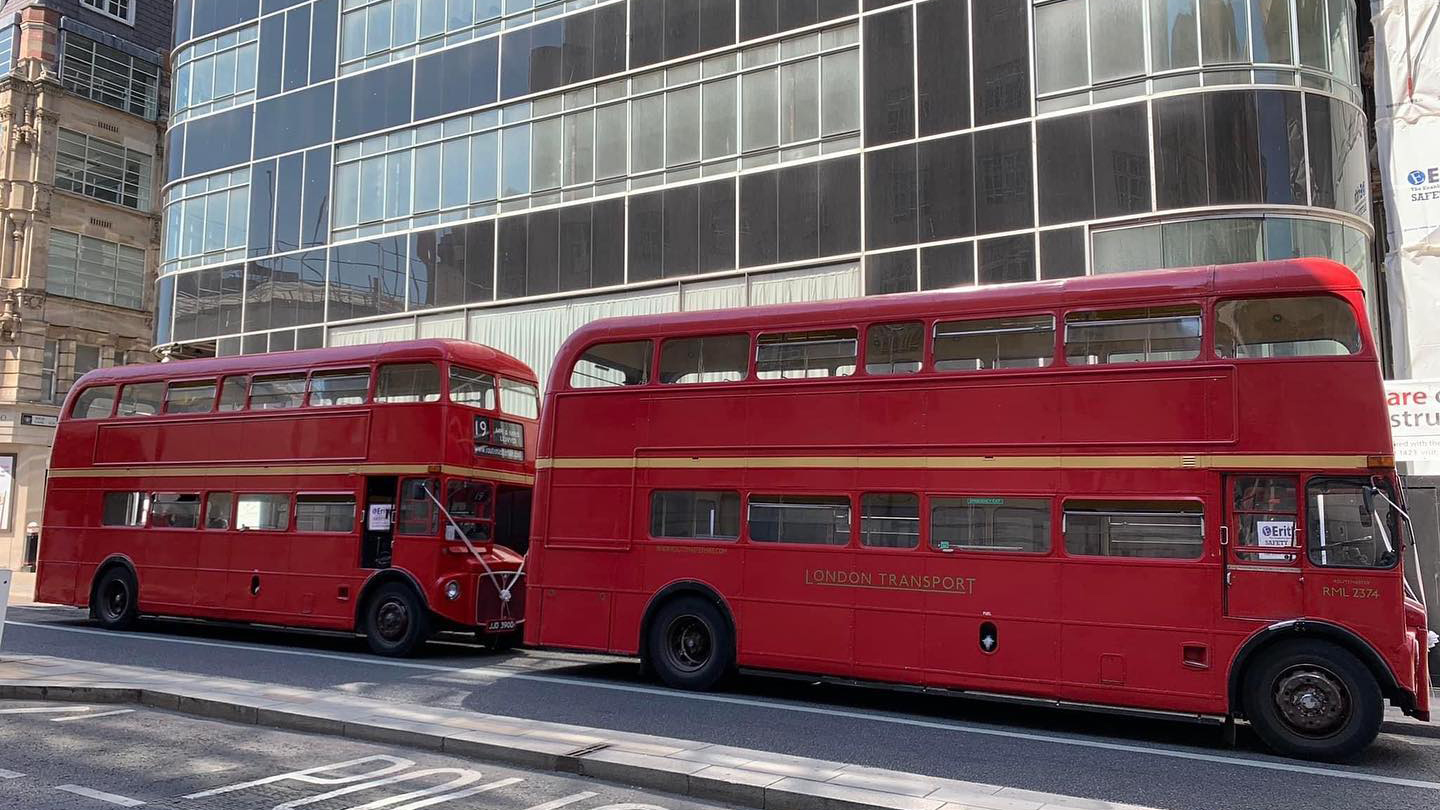 Two Red Double Decker Routemaster Buses in the Street of London