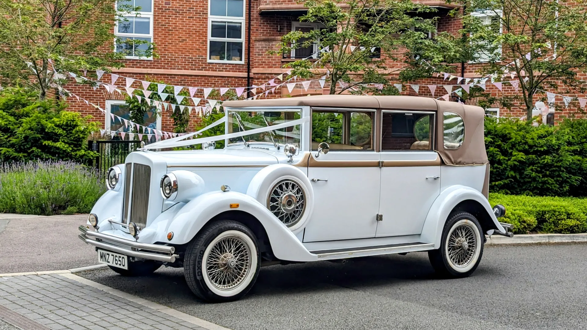 White Regent convertible with soft top roof closed in the street of Manchester