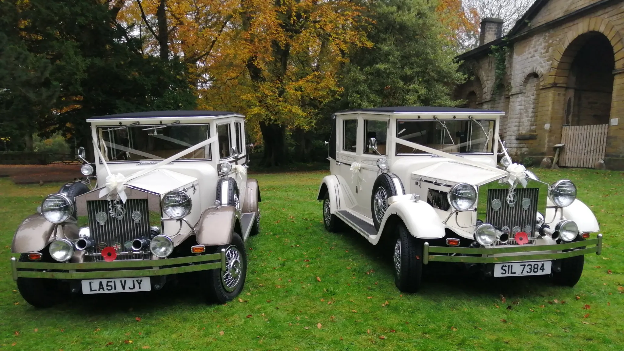 Two Imperial cars decorated with matching ivory ribbons in front of a church in Sheffield.