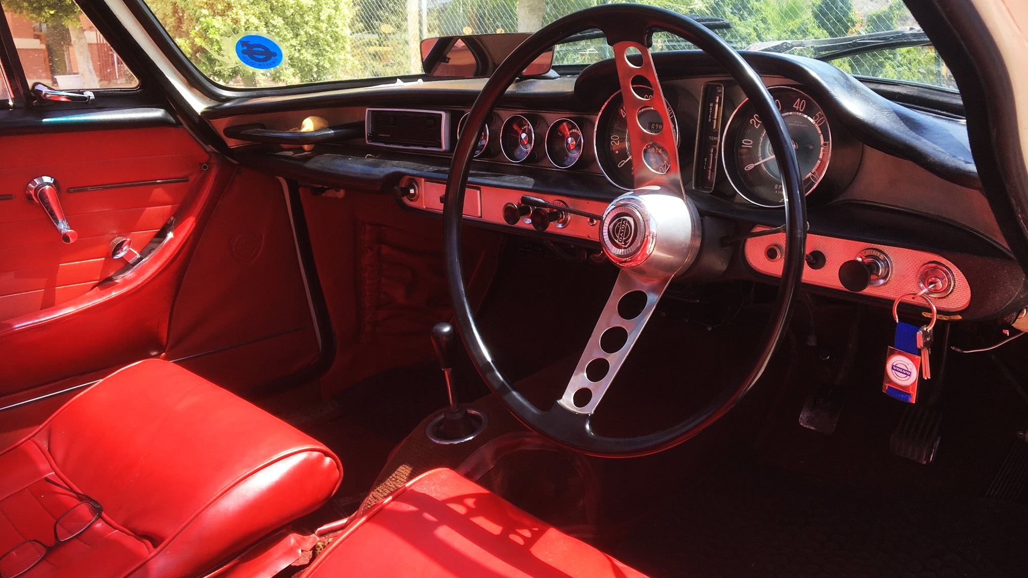 Red Leather front seating interior inside a Classic Volvo P1800S