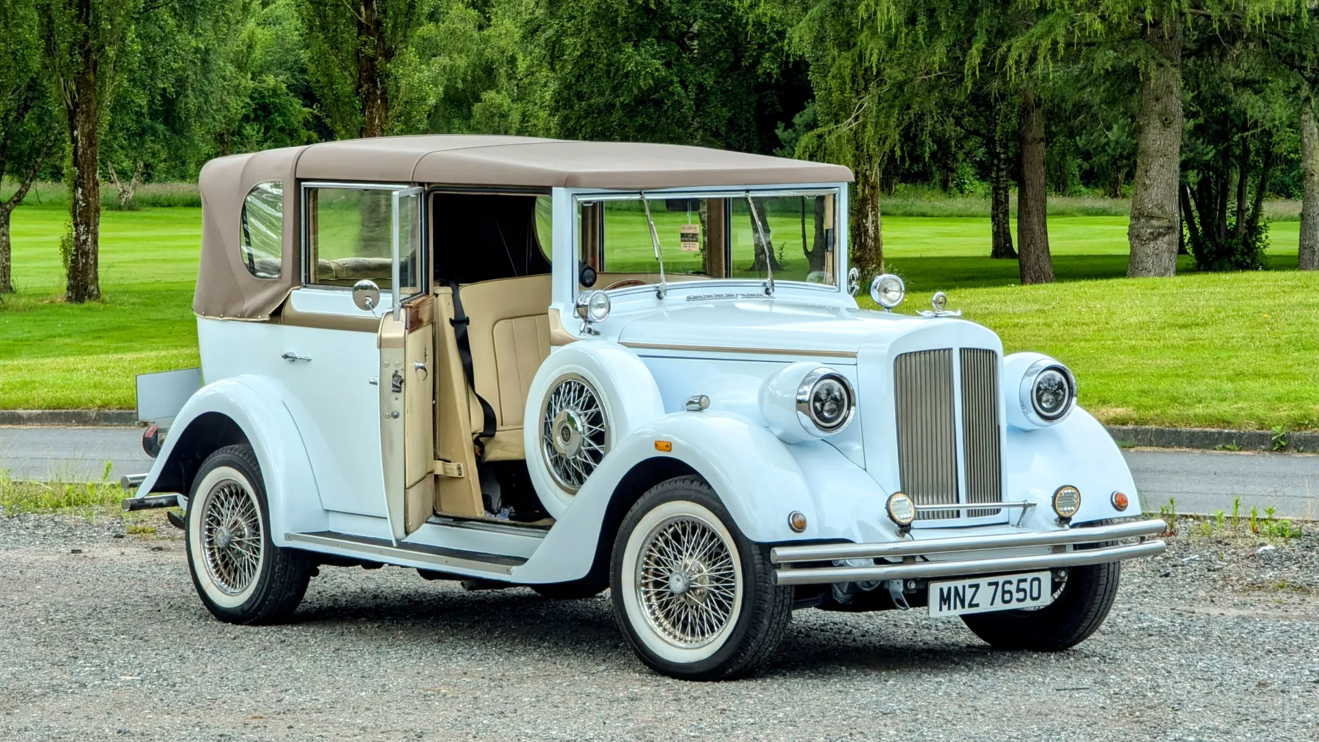 White Regent with front driver's door open. Door opens backward. Soft top roof is closed