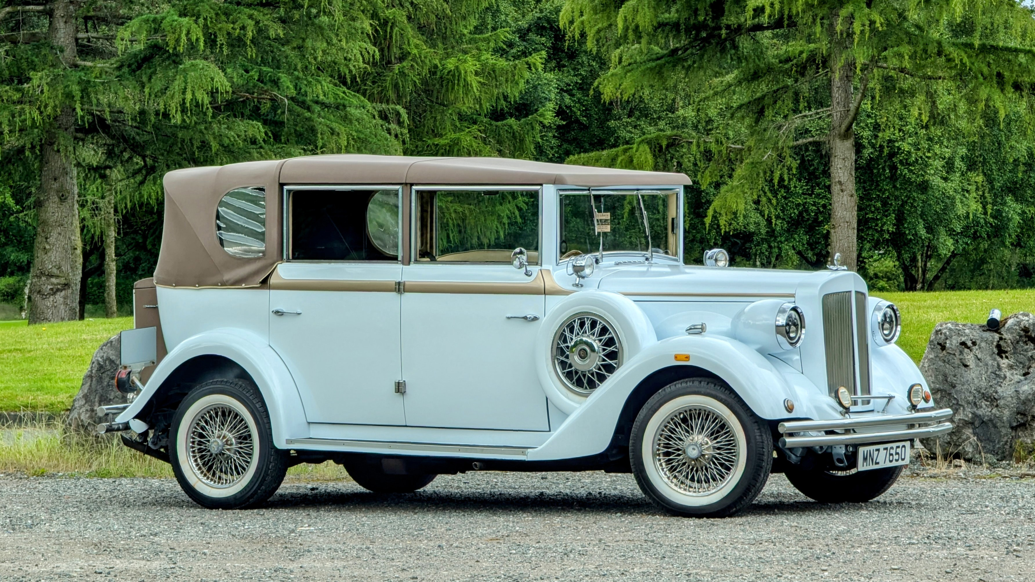 Side view of White Regent Convertible with roof up