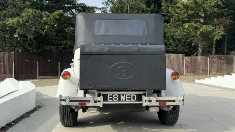 Rear view of Beauford with black soft top and black picnic trunk