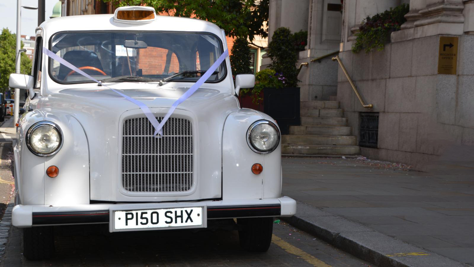 Front view of Classic Taxi Cab with White Ribbons