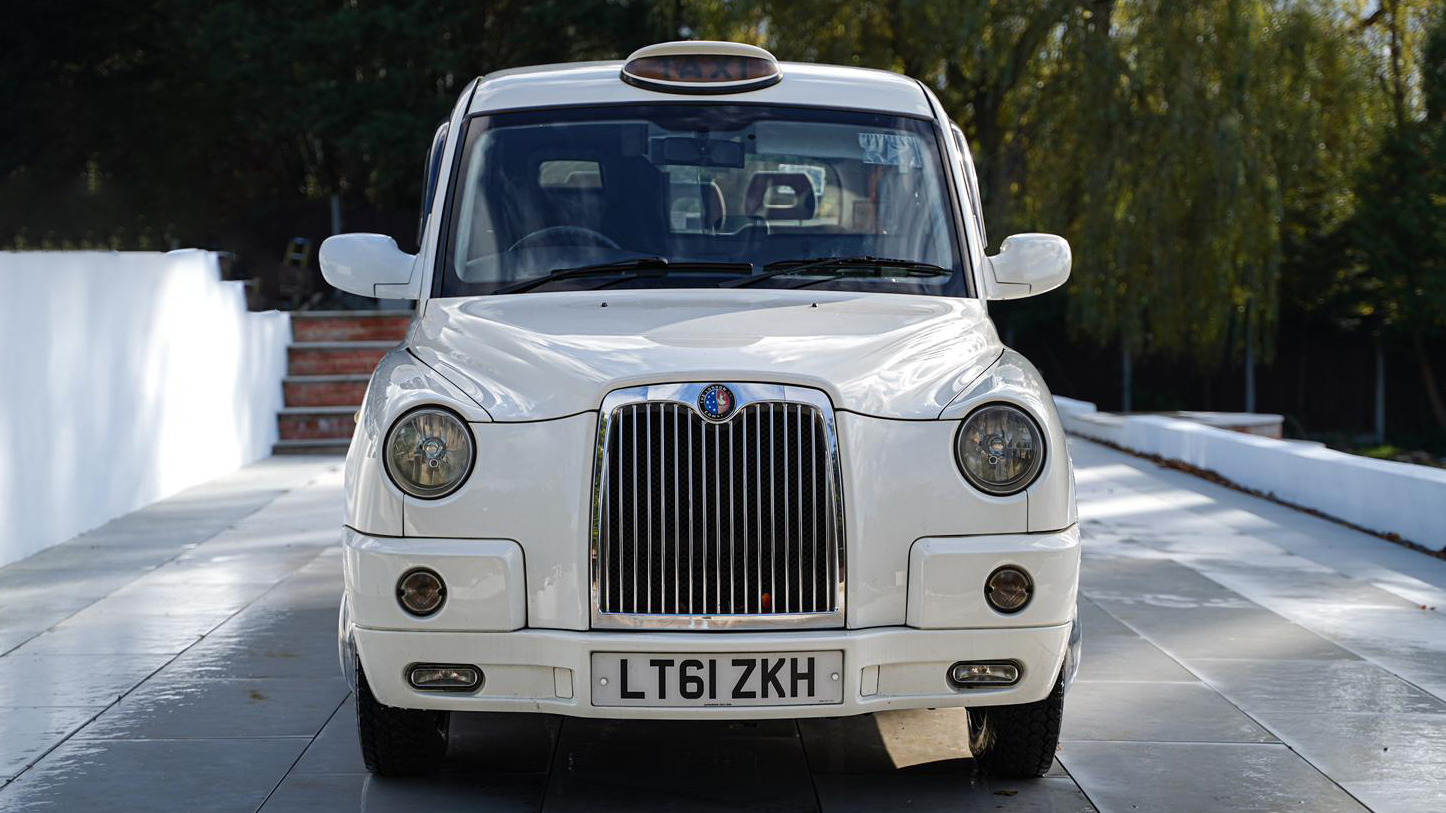 Full front view of white modern Taxi Cab