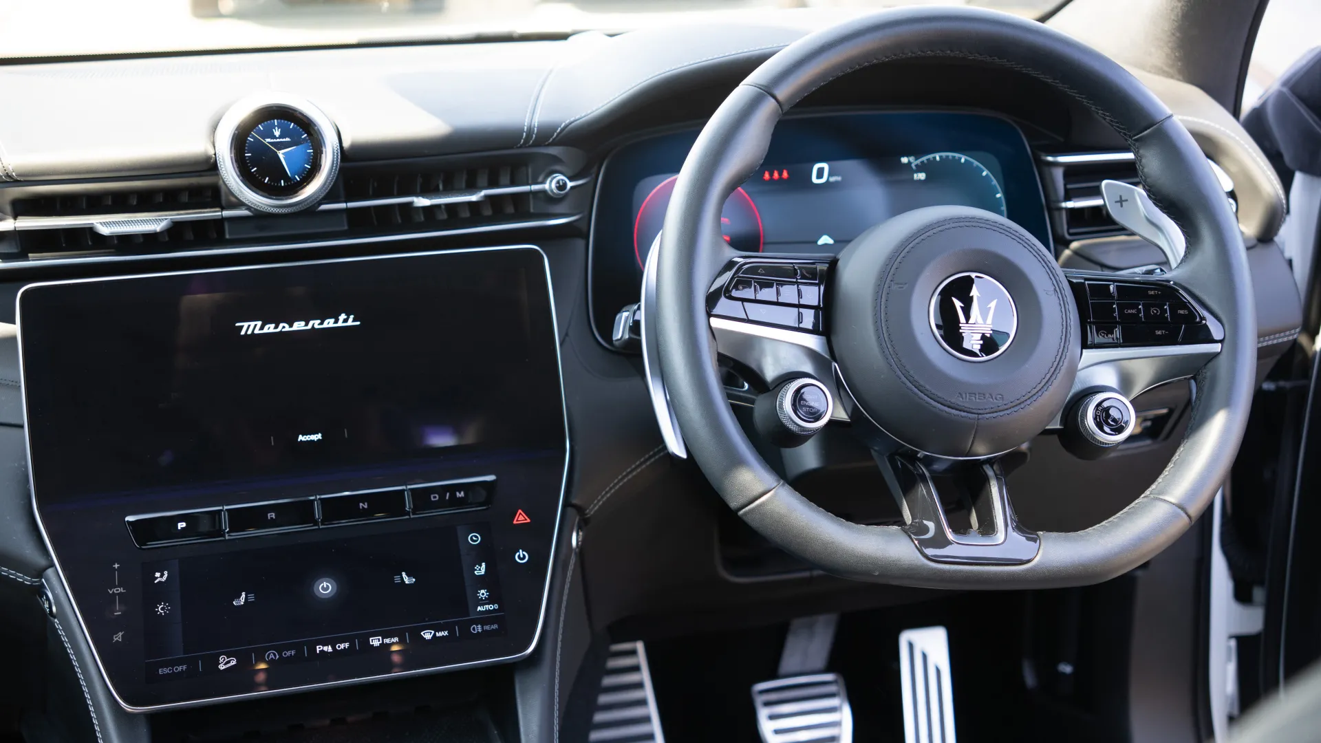 Front Driver steering wheel and dashboard inside a White Maserati Grecale