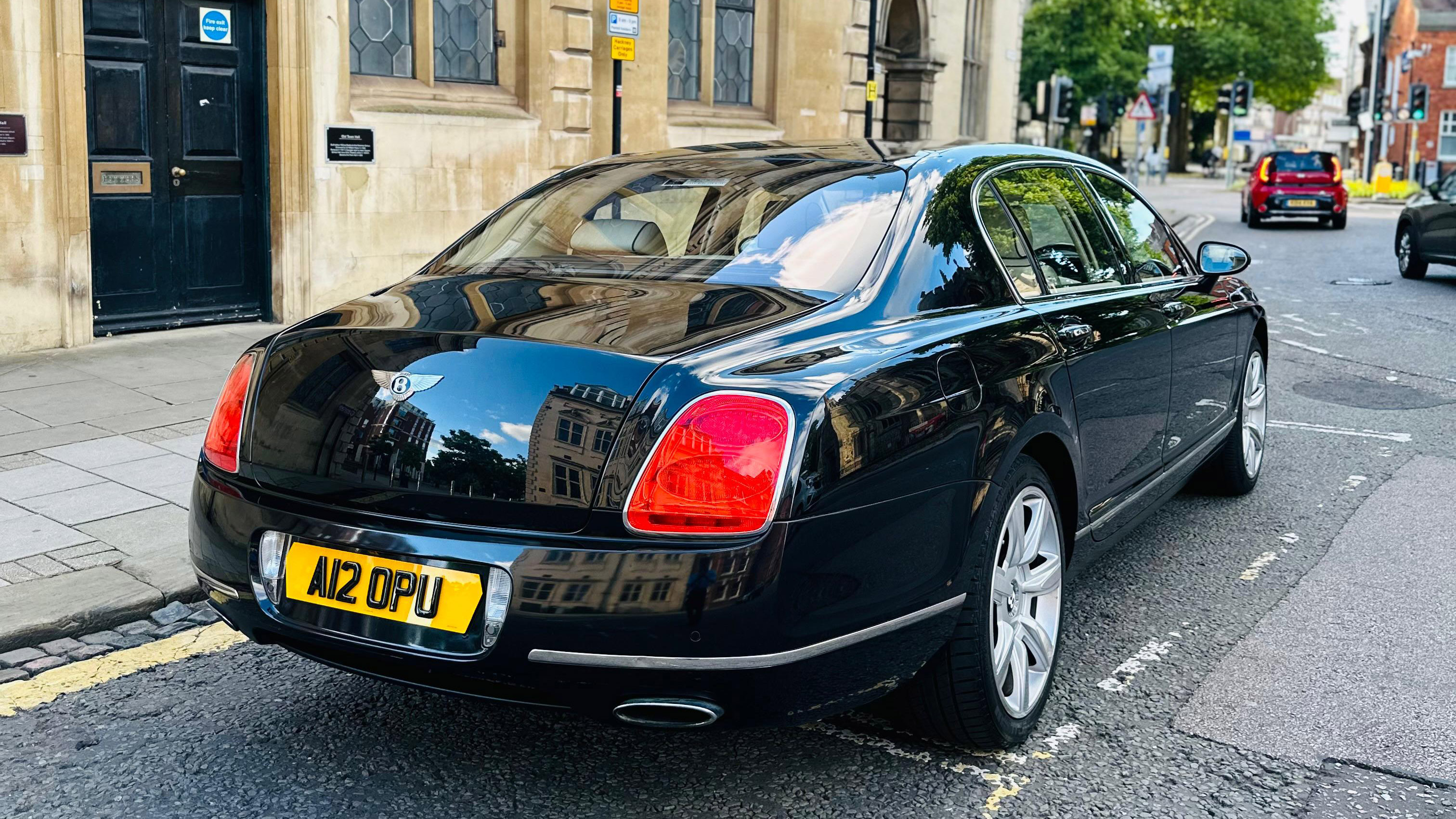 Right rear view of Black Bentley with large rear lights