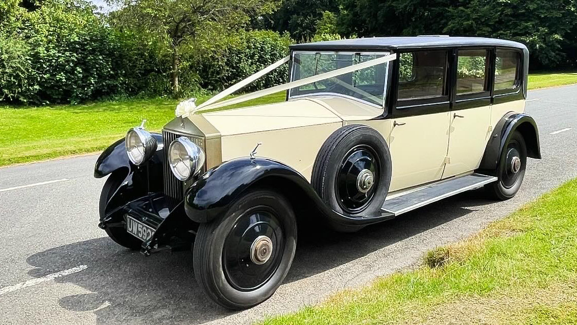 Left side view of vintage rolls-royce decorated with traditional Ivory Ribbon
