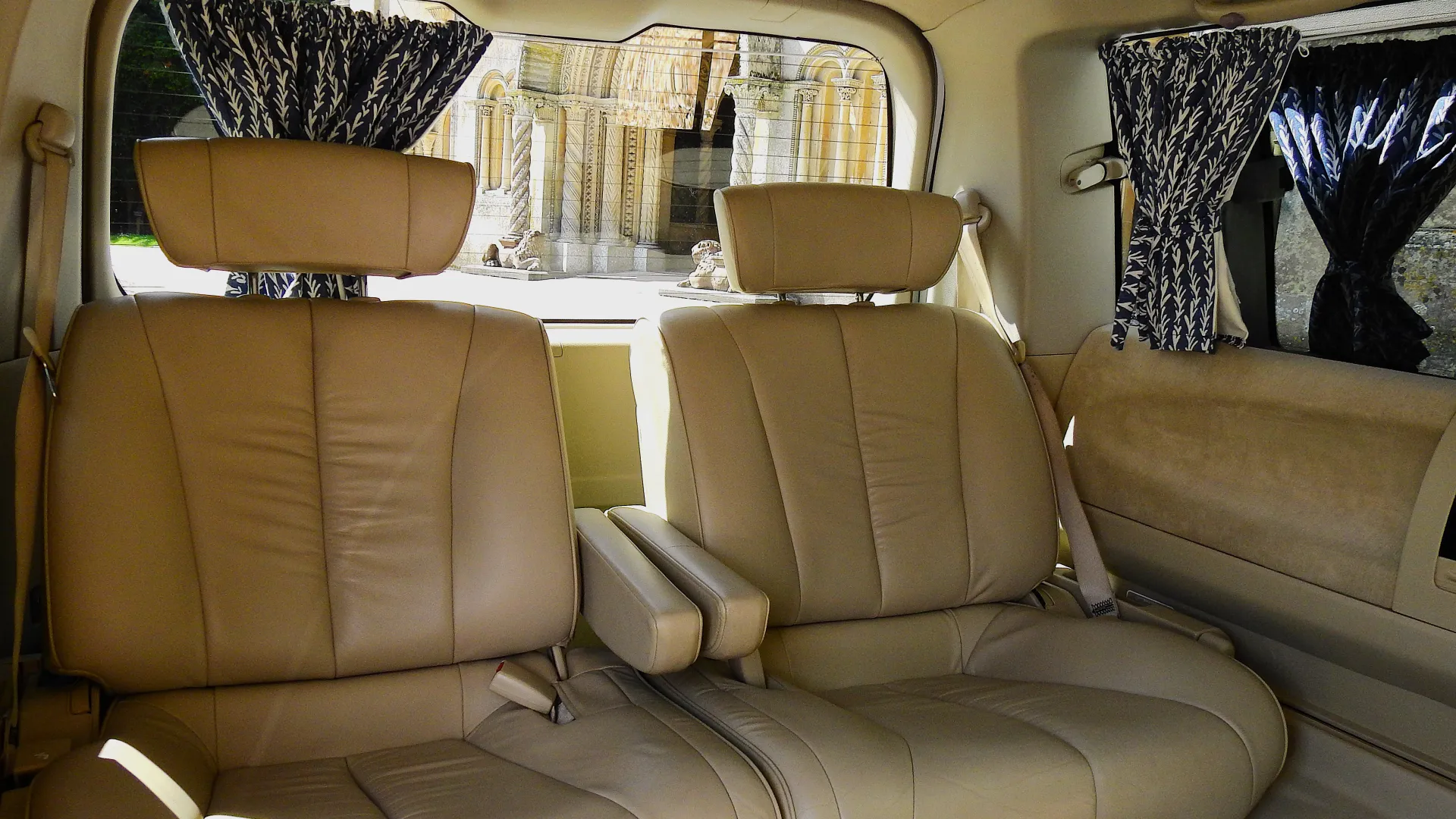 Interior back seats inside Nissan Elgrand. Seats are large spacious Cream Leather with armrests