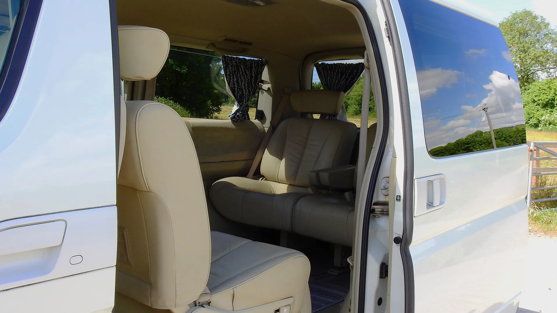 interior view of Nissan Elgrand showing spacious and curtains on rear windows