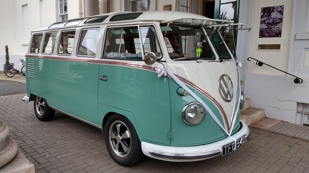 Right view of campervan in pale green and white with white ribbons and front splitcreen windows open